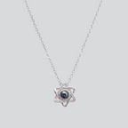 A silver six-pointed star pendant necklace with a dark blue center stone, displayed on a black velvet jewelry box with white text reading 'six-pointed Star Love'.